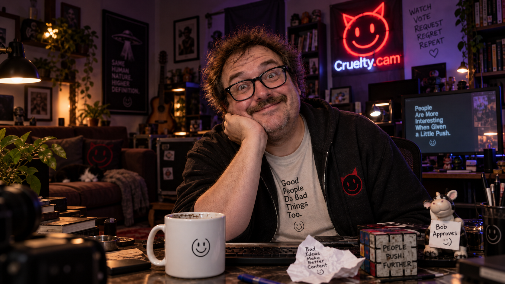 Bob at his desk, wearing glasses and a charcoal hoodie